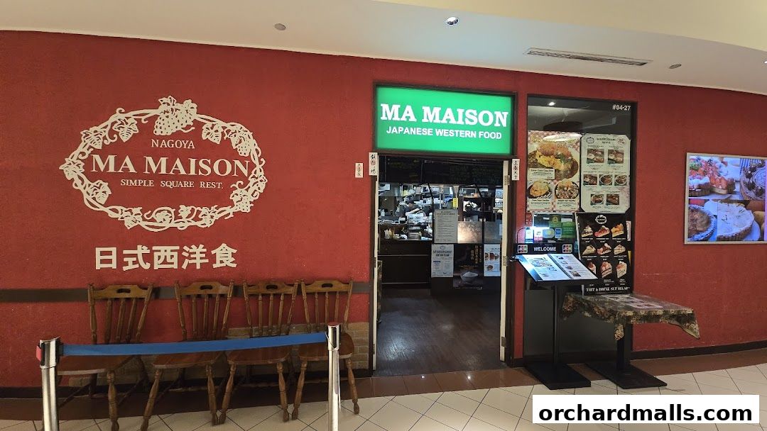 The entrance of Ma Maison, a Japanese Western food restaurant, with a red wall and menu displays.