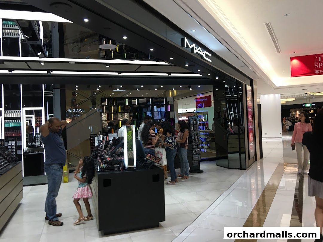 MAC Cosmetics store entrance with customers browsing makeup displays.