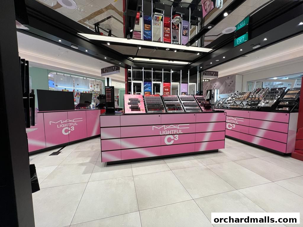 MAC Cosmetics store interior with pink counters displaying makeup products.