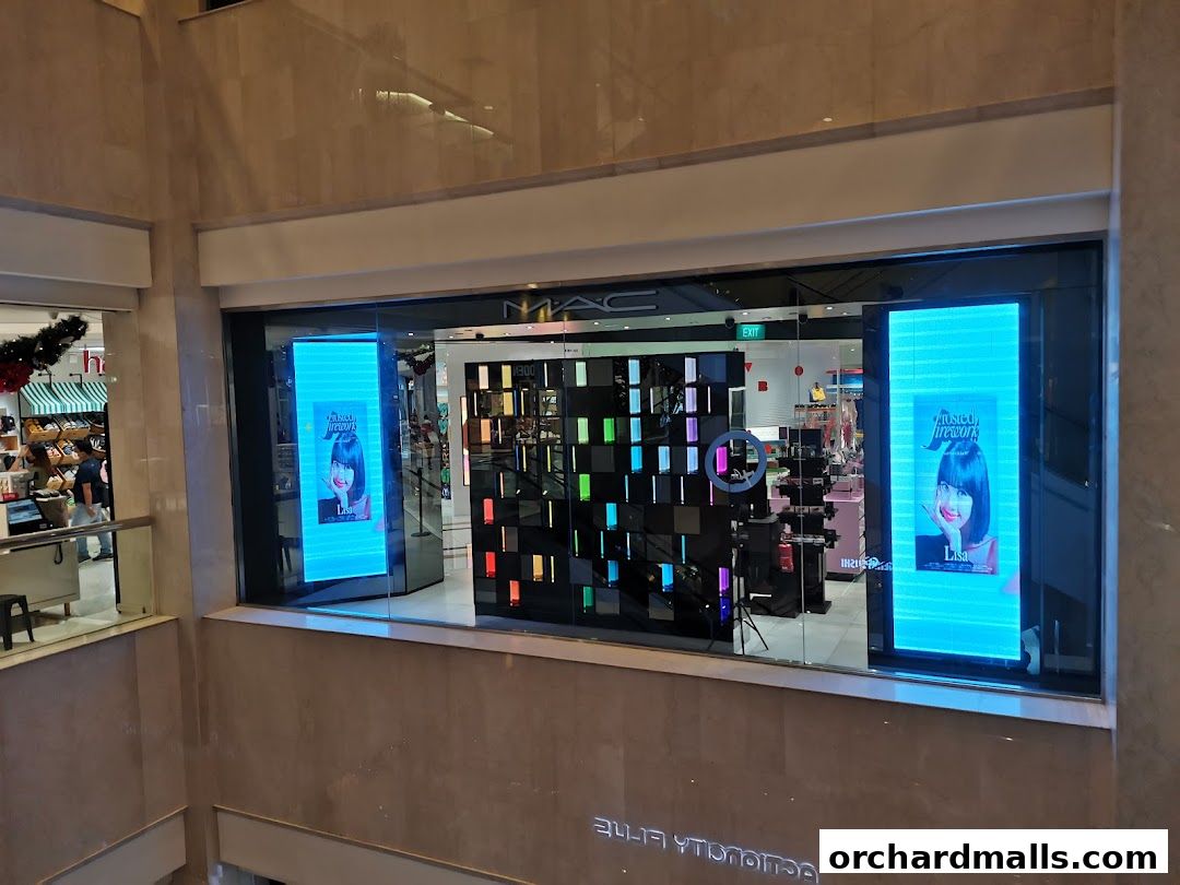 MAC Cosmetics store front with digital displays and product shelves visible inside.