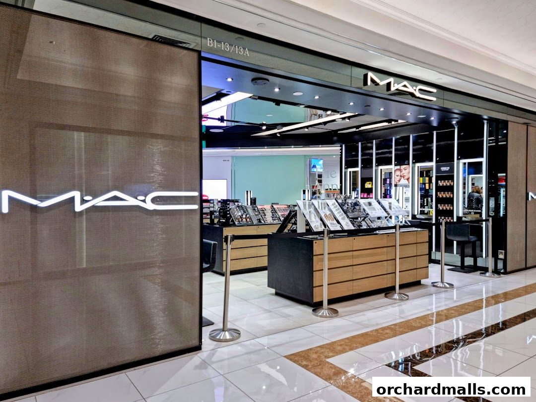 The exterior of a MAC Cosmetics store with illuminated signage and product displays.