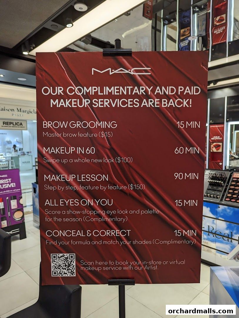 A sign advertising MAC Cosmetics' complimentary and paid makeup services.