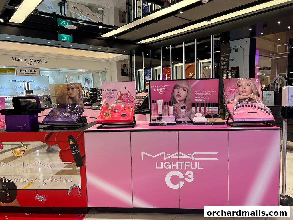 MAC Cosmetics store display featuring makeup products and promotional images.