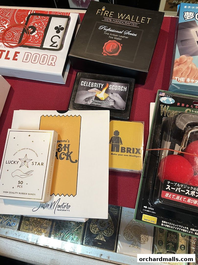 A collection of magic tricks and accessories, including wallets, rubber bands, and card decks.