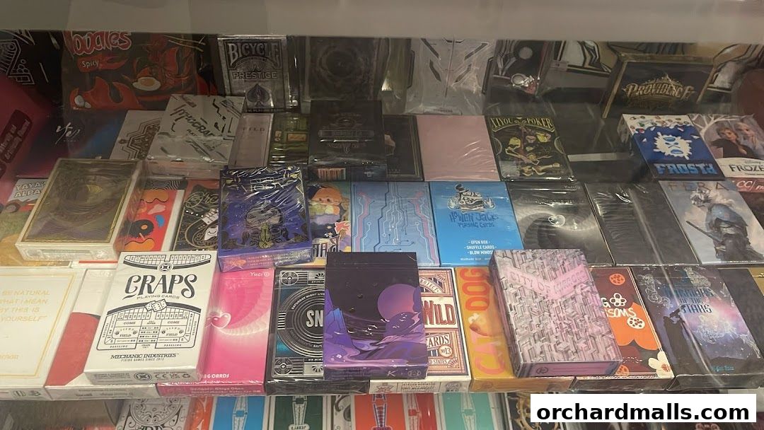 A display of various decks of playing cards with unique designs and themes.