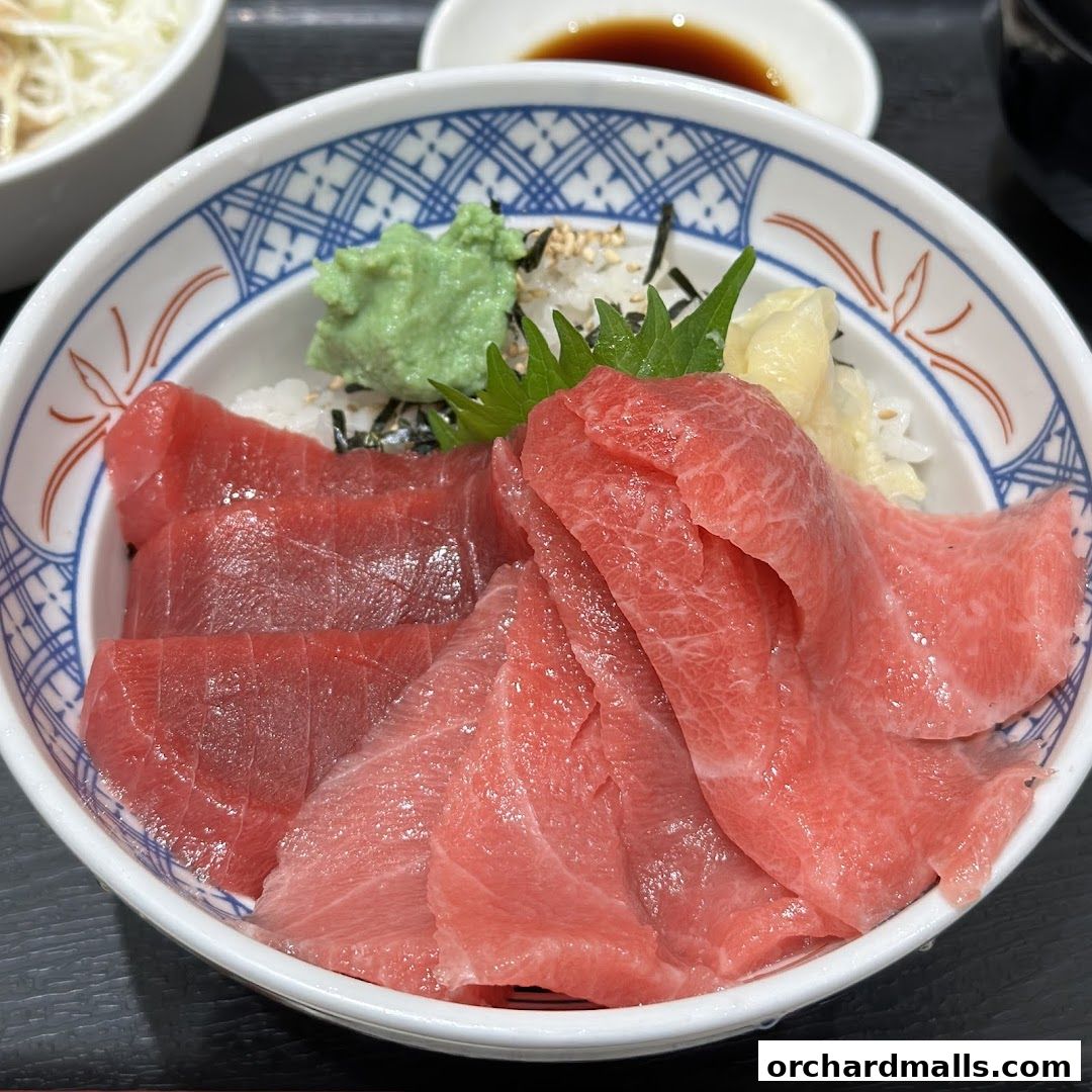 A close-up of a delicious tuna donburi with fresh tuna slices on rice.