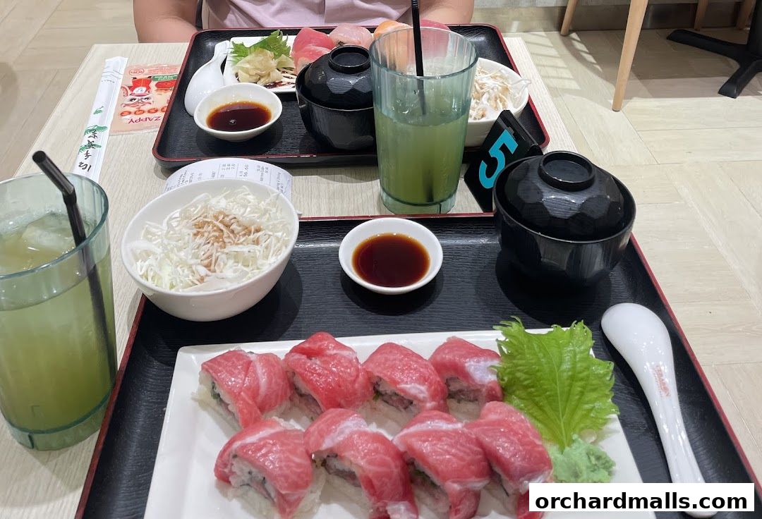 A table setting with sushi, drinks, and side dishes at Maguro Yukimitsu.