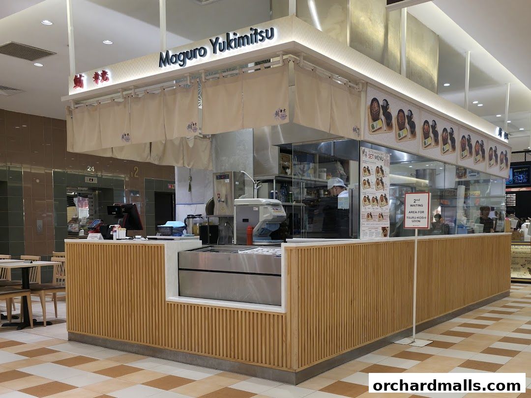 A Japanese restaurant counter with a menu and seating area visible.