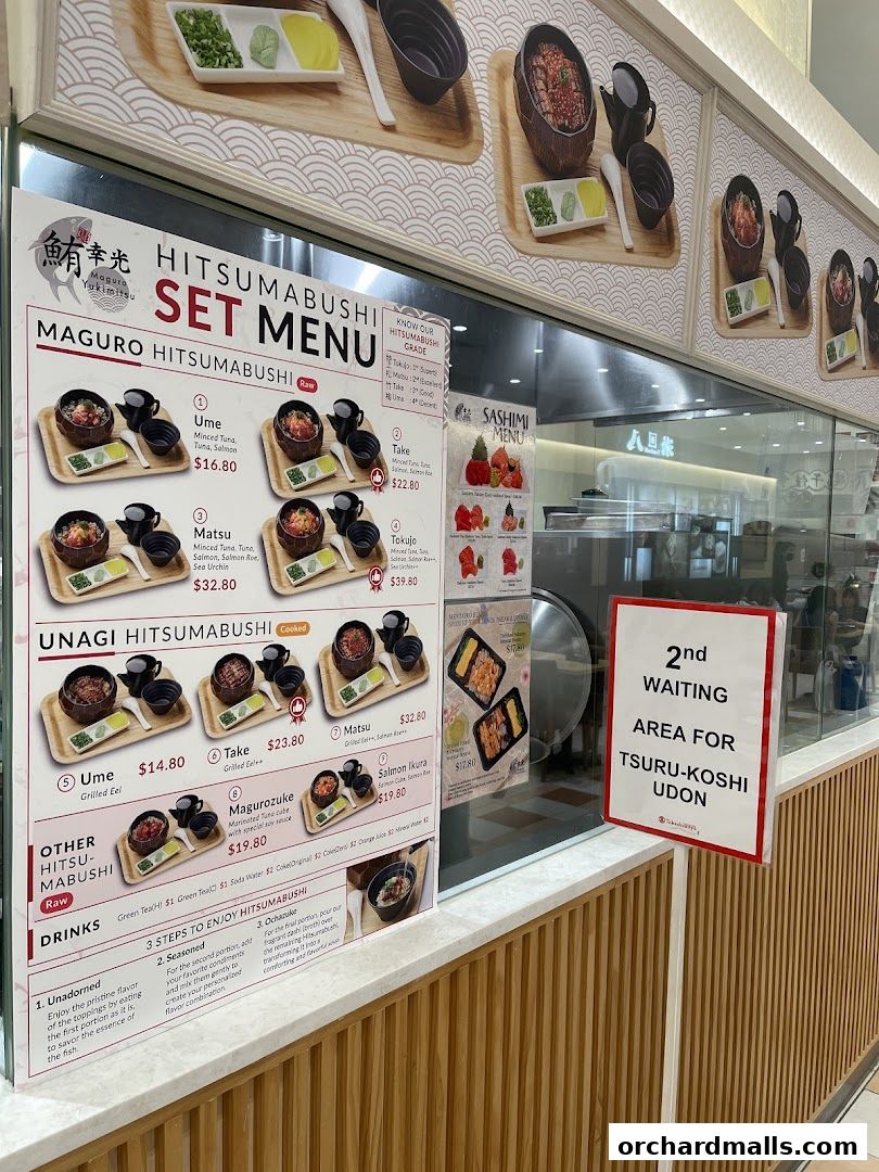A menu board for Maguro Yukimitsu, showcasing Hitsumabushi sets and sashimi.