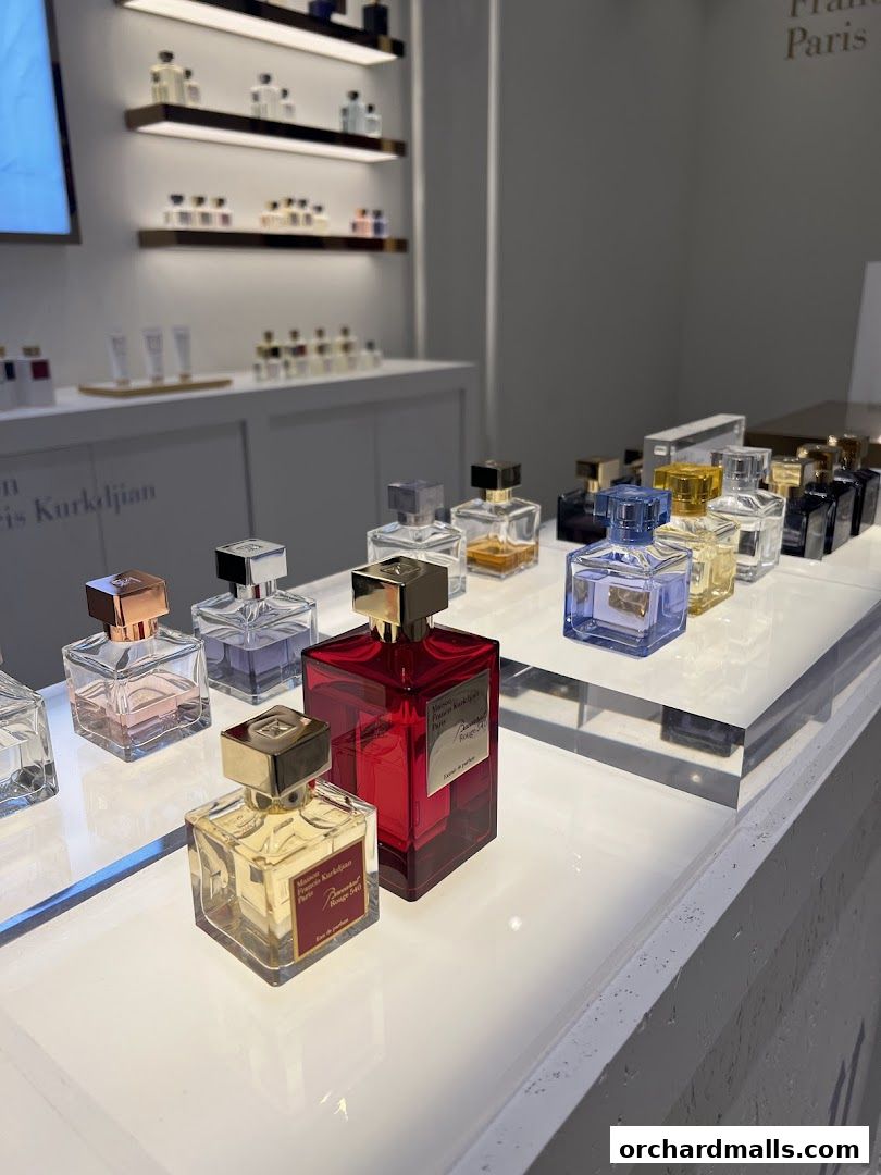 A display of various Maison Francis Kurkdjian perfumes in elegant bottles.