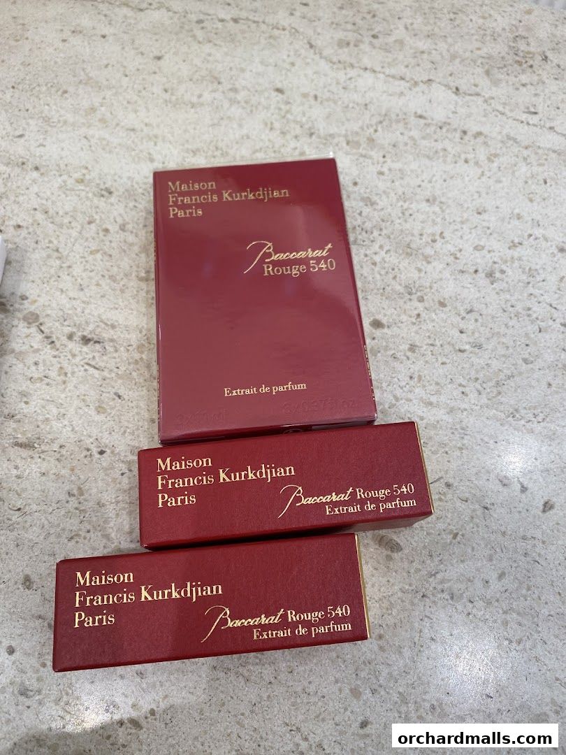 Three red boxes of Maison Francis Kurkdjian Baccarat Rouge 540 perfume.
