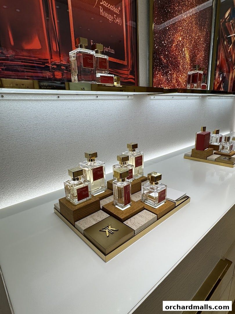 Elegant display of Maison Francis Kurkdjian perfumes on a white counter.