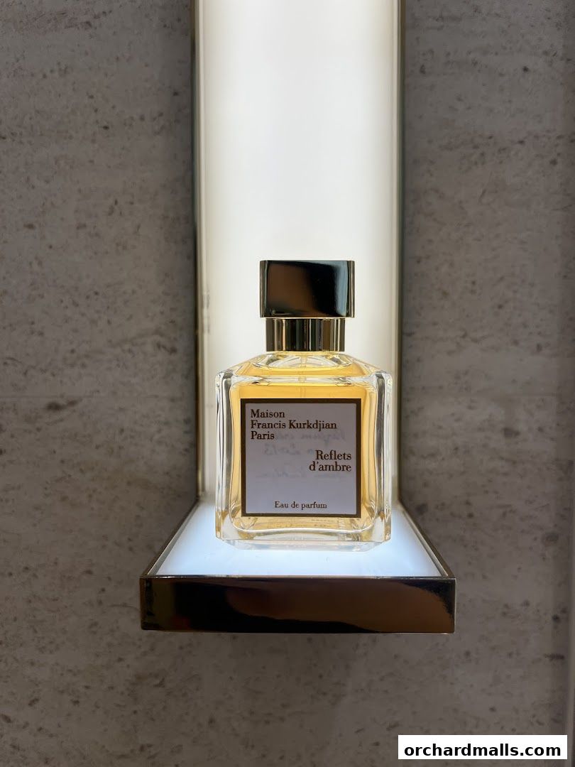 A bottle of Maison Francis Kurkdjian 'Reflets d'ambre' Eau de Parfum displayed on a shelf.