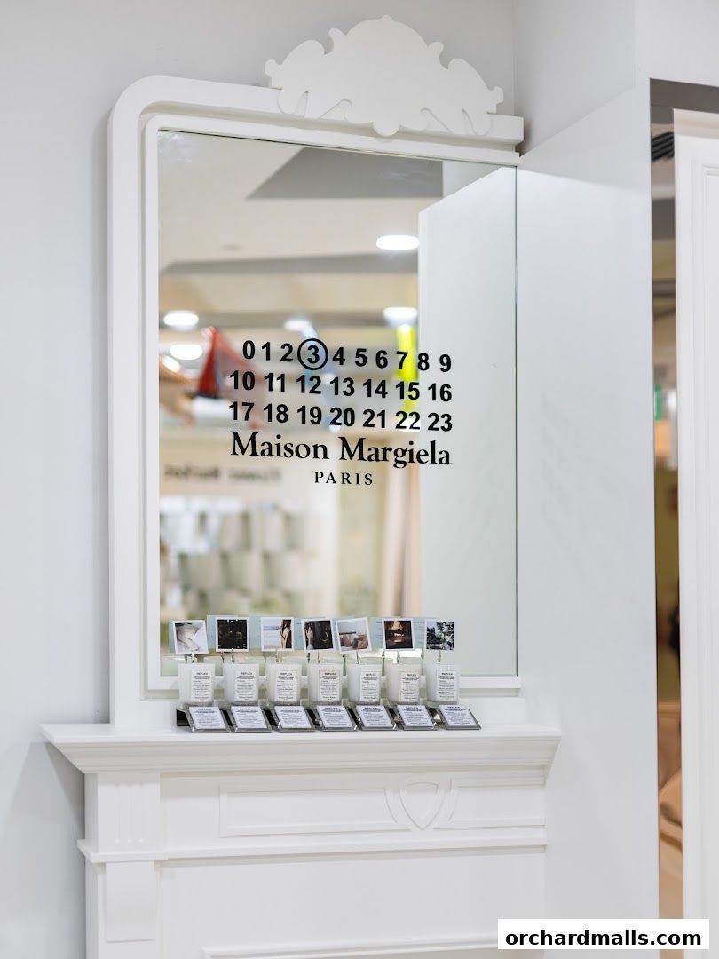 Maison Margiela store interior featuring a mirror with brand logo and display of replica candles.