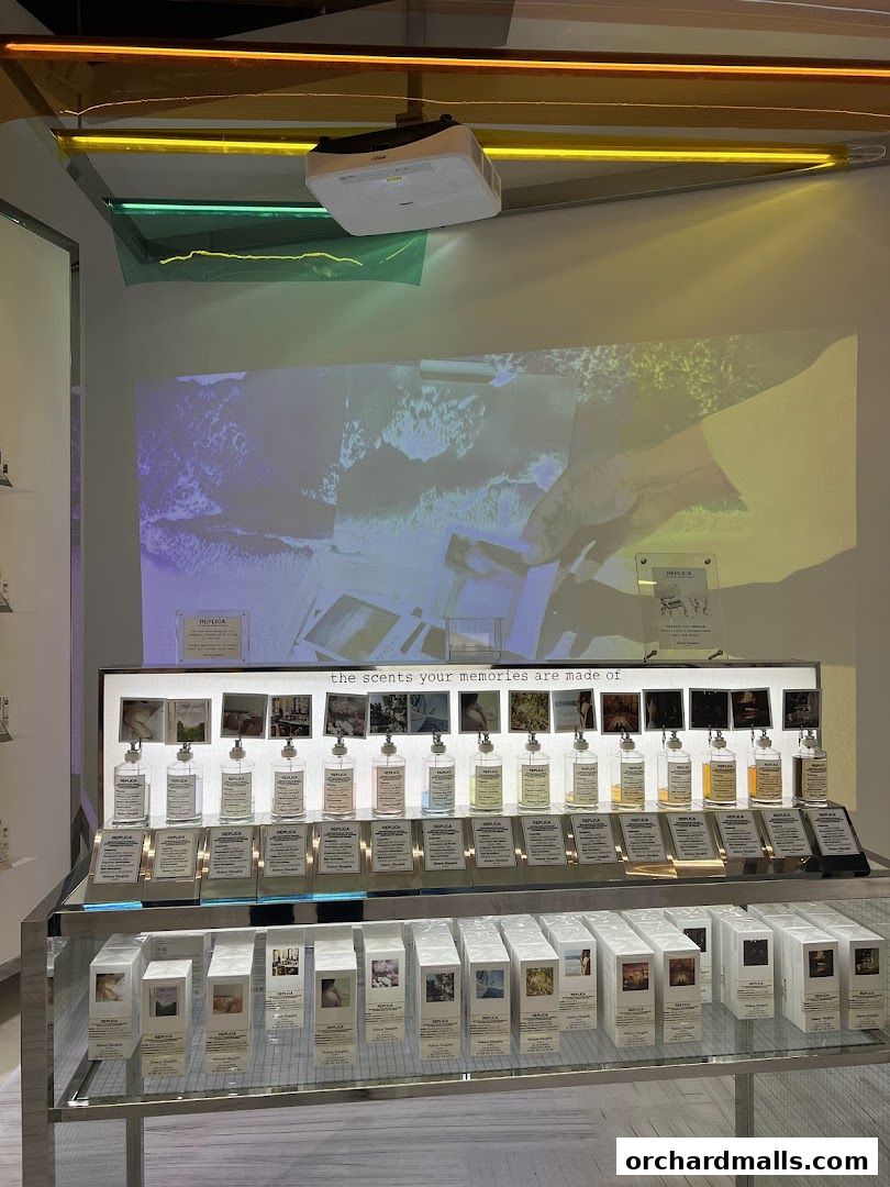 Maison Margiela display featuring Replica fragrances with evocative imagery and scents.