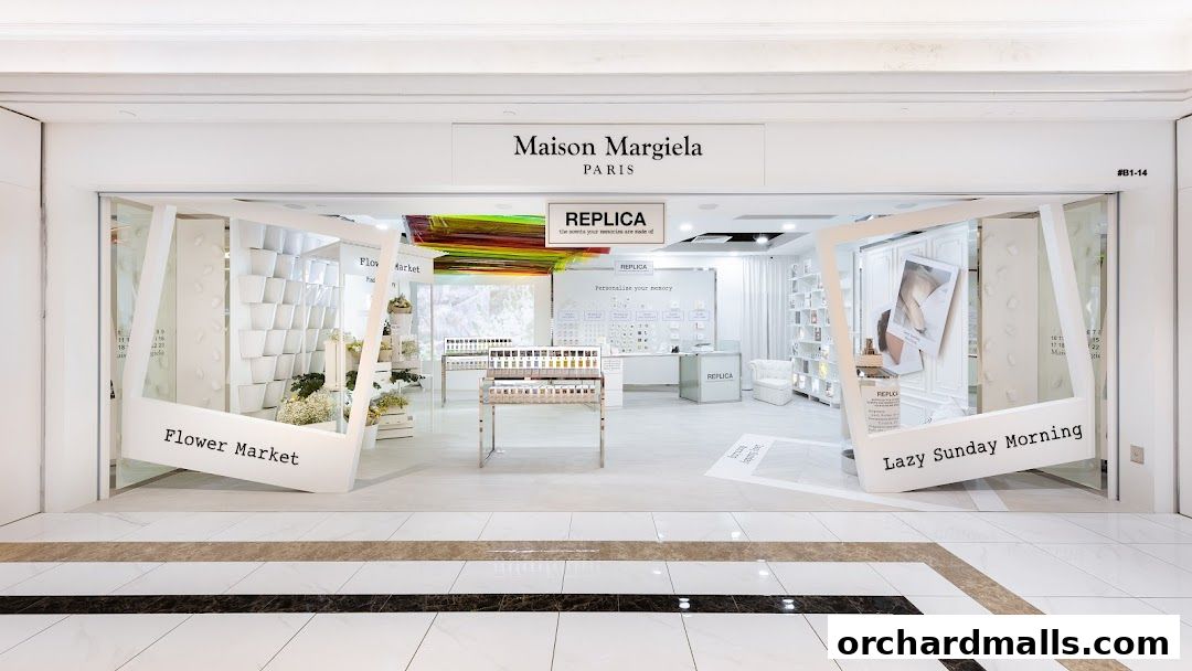 Maison Margiela Paris store entrance featuring Replica fragrances and floral displays.
