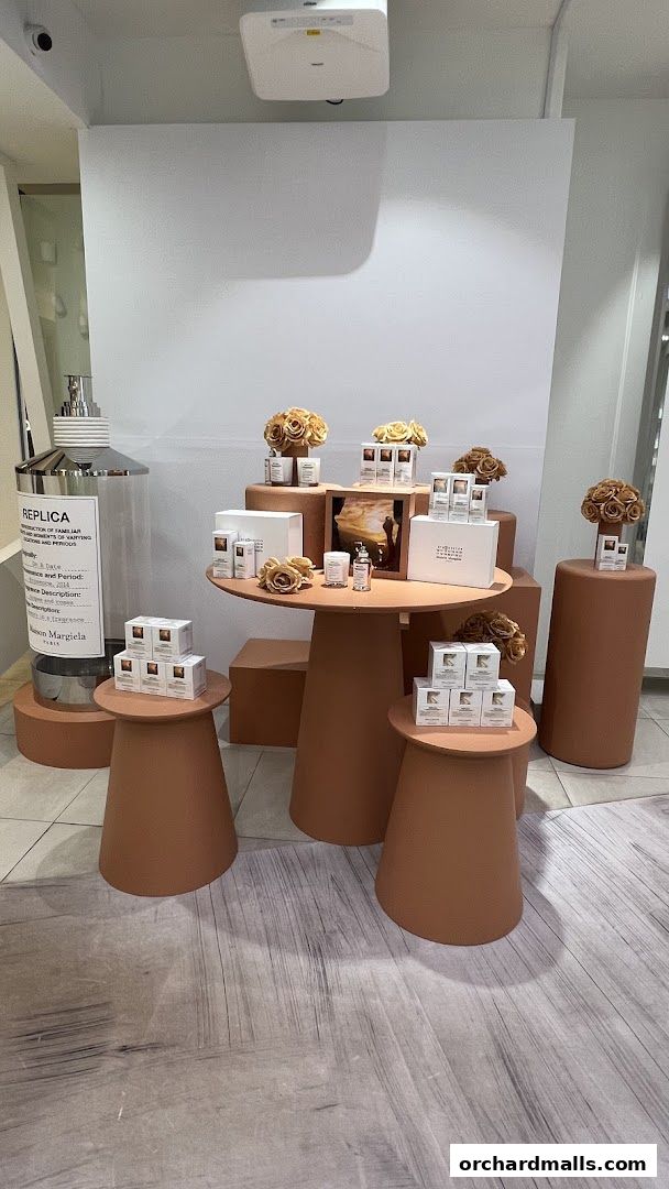Maison Margiela display featuring Replica fragrances and decorative elements.