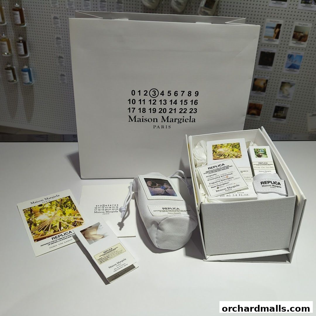 Maison Margiela REPLICA fragrances and branded shopping bag.