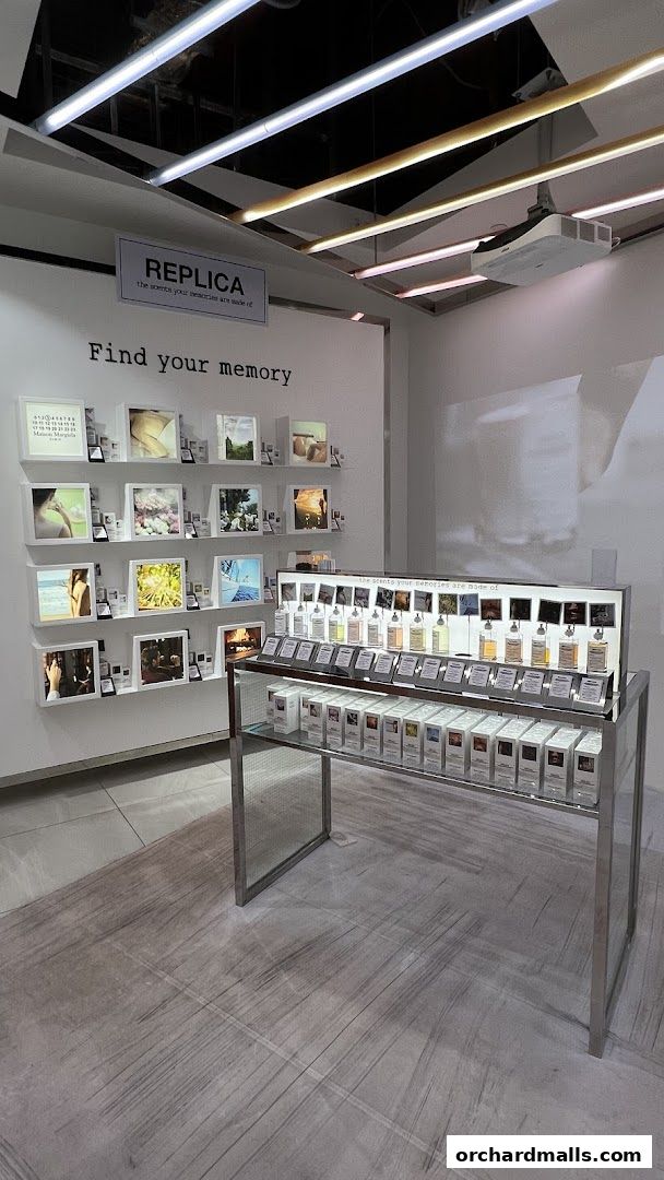 Maison Margiela Replica fragrances displayed with evocative imagery and product boxes.