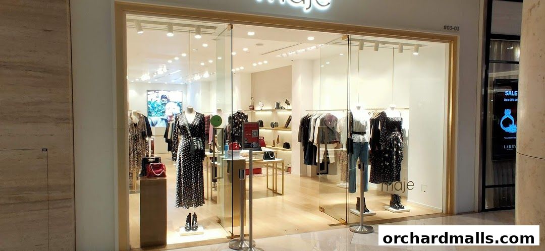 The Maje store features a well-lit interior with mannequins displaying stylish dresses and accessories.