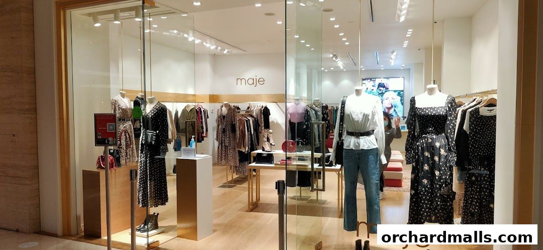 The Maje store features a well-lit interior with mannequins displaying stylish dresses and outfits.