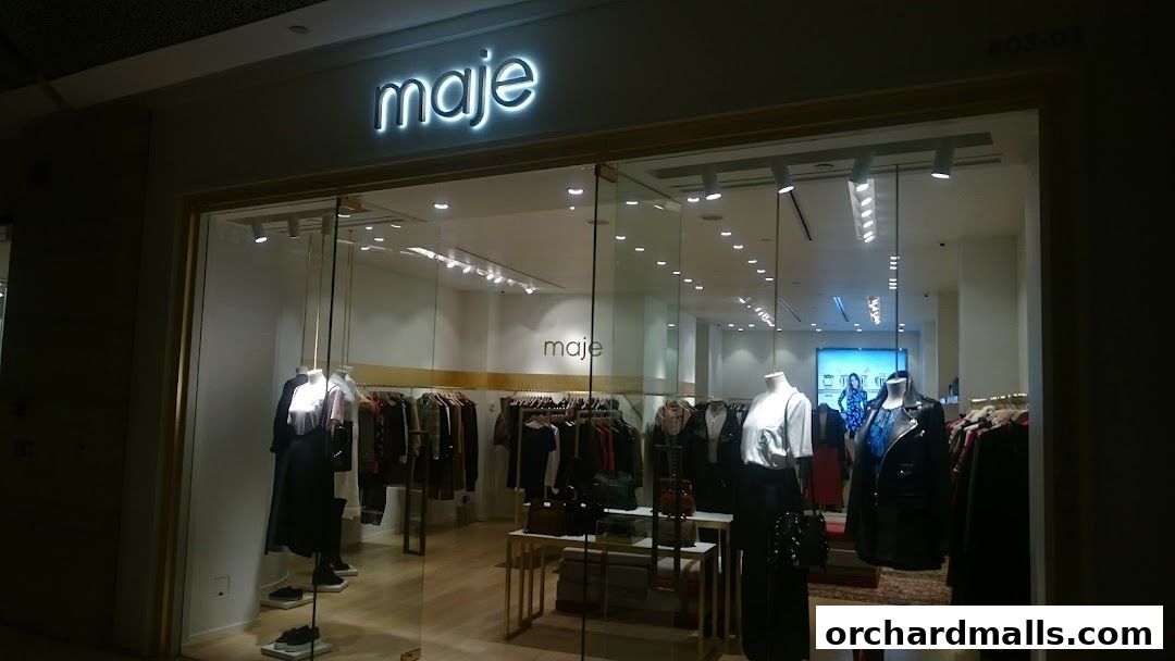 The Maje store entrance displays mannequins and clothing racks with fashionable apparel.