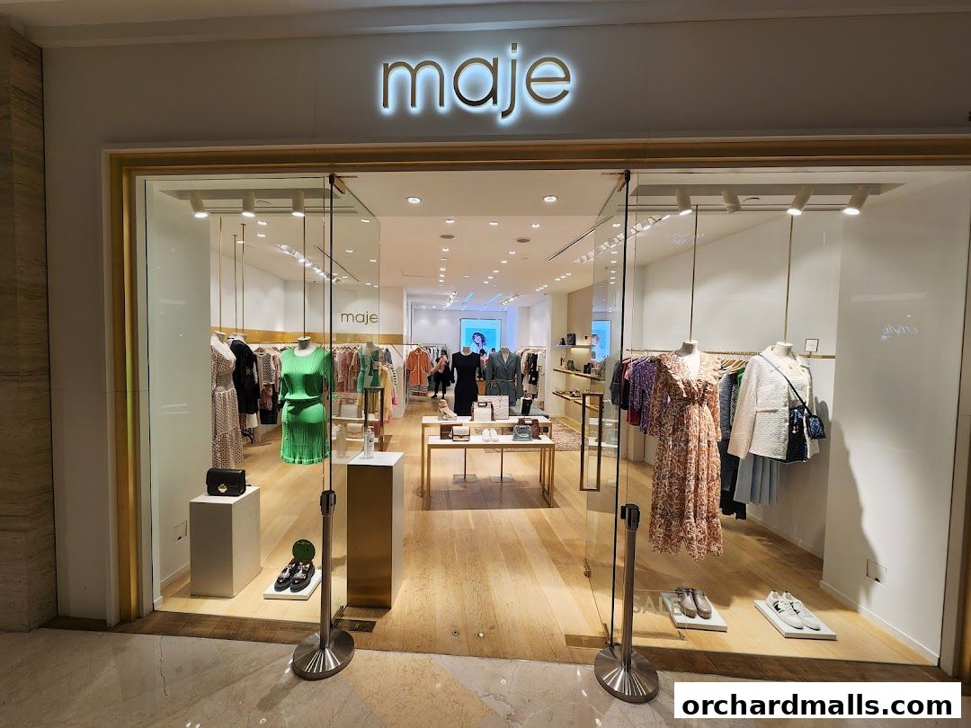 The Maje shop front displays a curated selection of women's fashion on mannequins and racks.