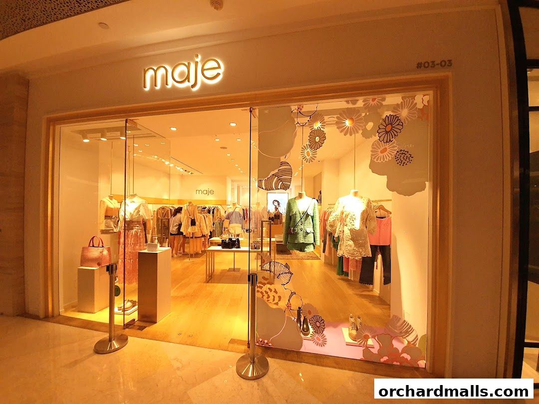 The Maje store entrance displays a well-lit interior with mannequins showcasing stylish clothing and accessories.