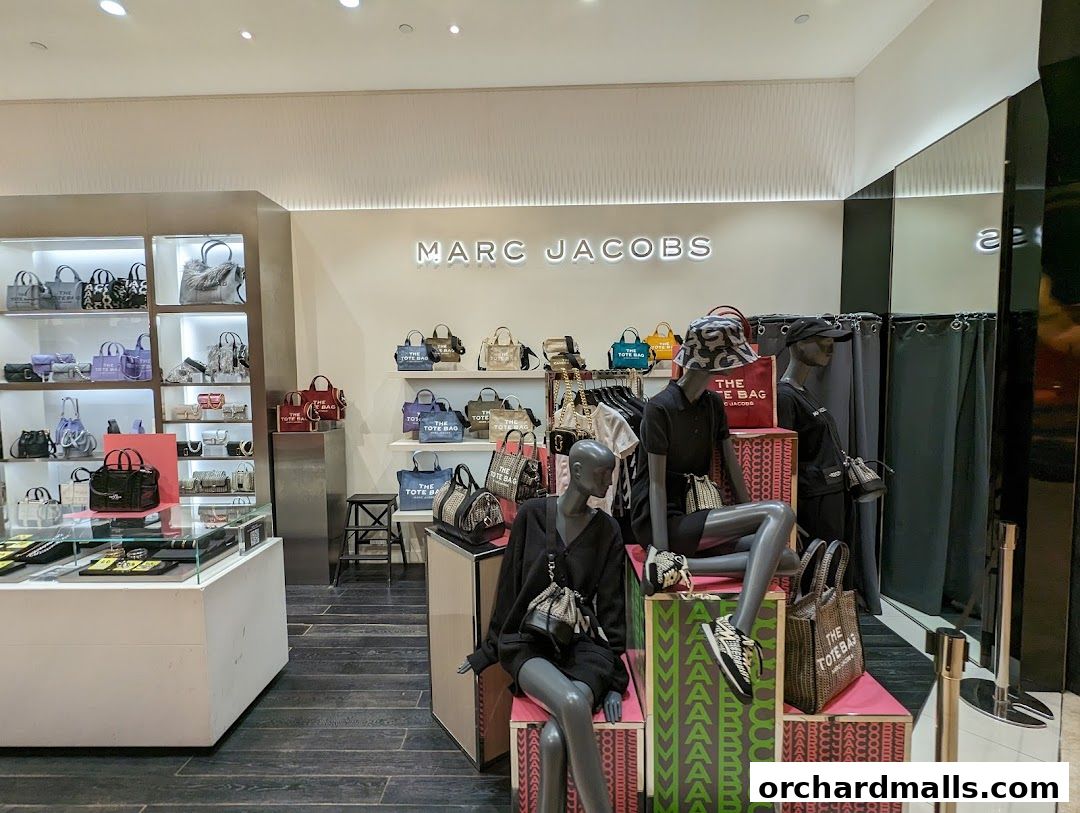 Interior view of a Marc Jacobs store showcasing handbags and accessories on display.