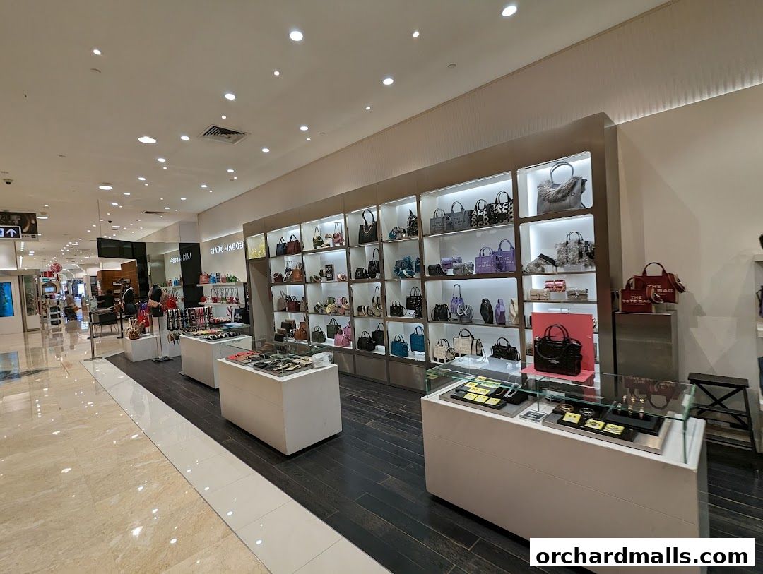 Interior view of a Marc Jacobs store showcasing handbags and accessories on display shelves.