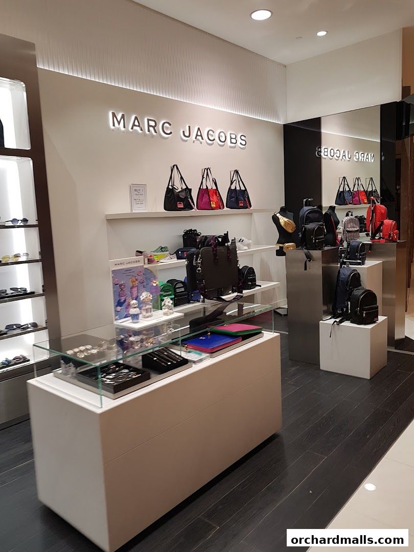 Interior view of a Marc Jacobs store showcasing handbags, backpacks, and accessories.