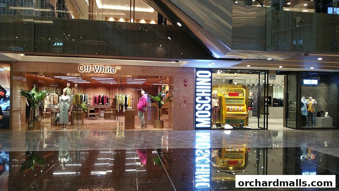 Exterior view of Off-White and Moschino fashion stores in a modern shopping mall.