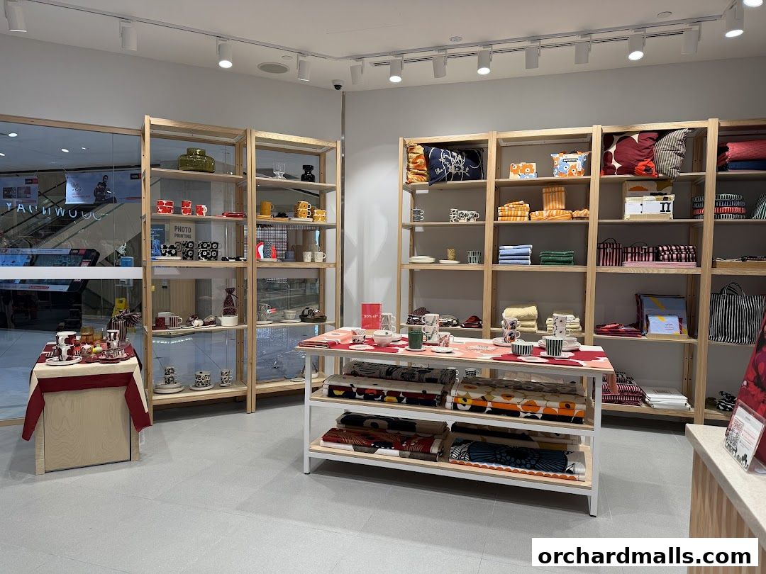 Interior of a Marimekko shop showcasing colorful home goods and textiles on shelves.