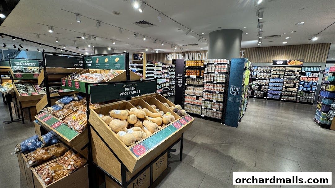 Interior view of a Marks & Spencer food store showcasing fresh produce and packaged goods.