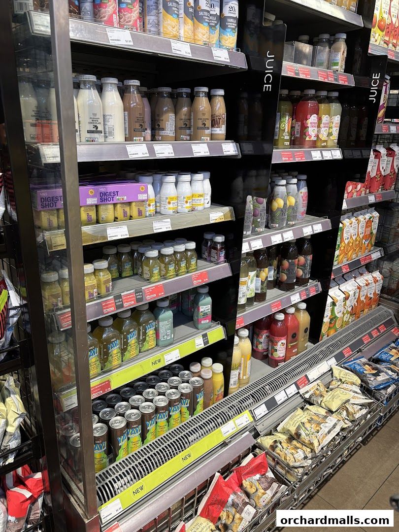 Shelves stocked with various beverages, including juices, milk drinks, and canned drinks.