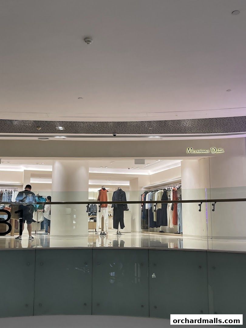 Interior view of a Massimo Dutti store with clothing displays and mannequins.