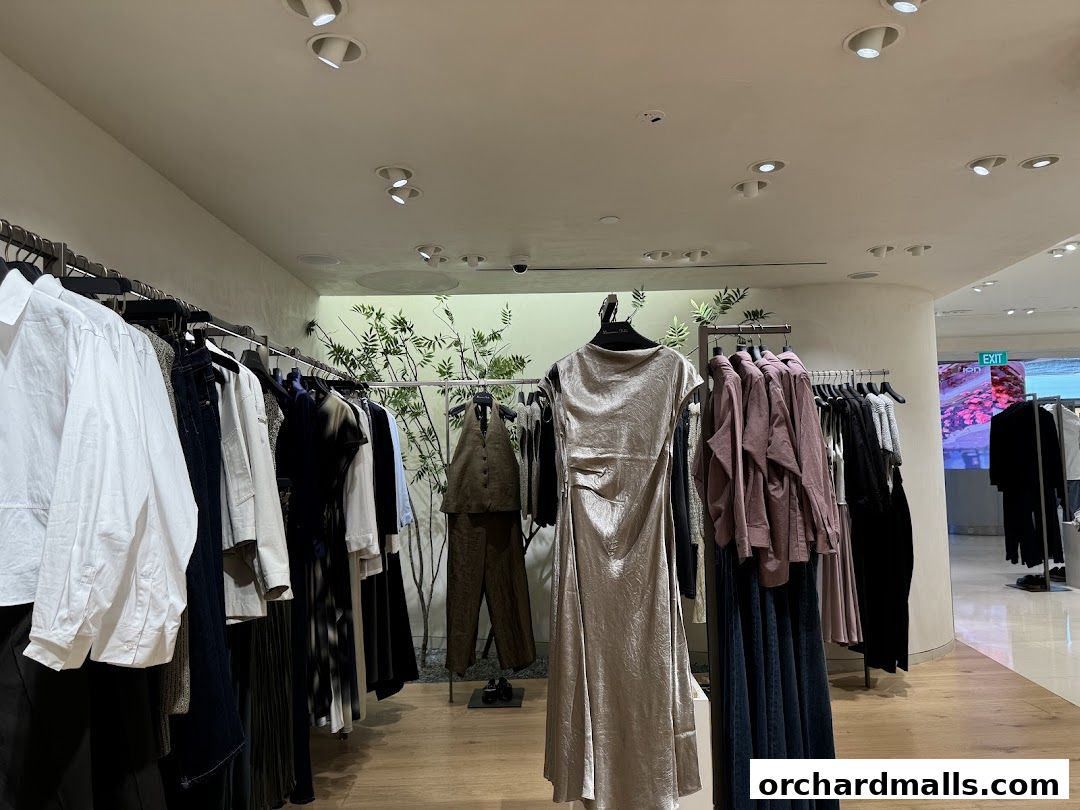 Interior view of a clothing store with racks of apparel and a mannequin.
