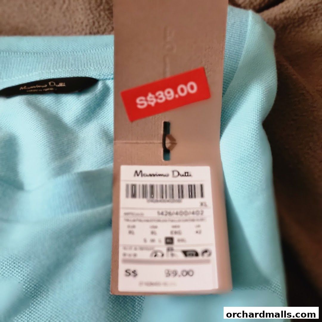 A close-up of a light blue Massimo Dutti polo shirt with a price tag showing S$39.00.
