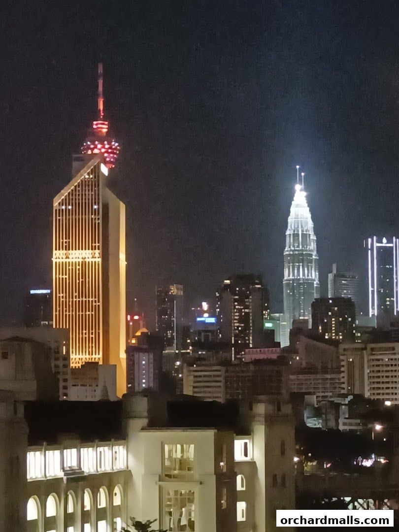 A nighttime cityscape featuring illuminated skyscrapers and buildings.
