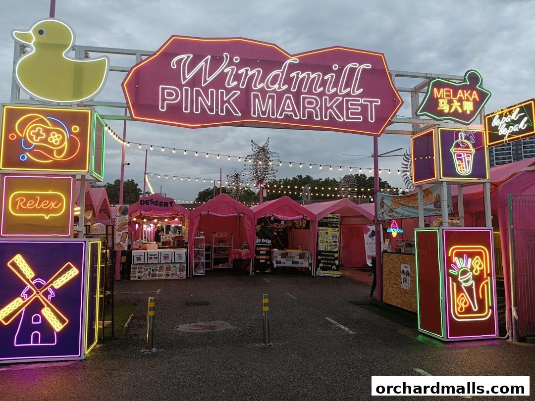 Entrance to Windmill Pink Market with neon signs and pink tents.