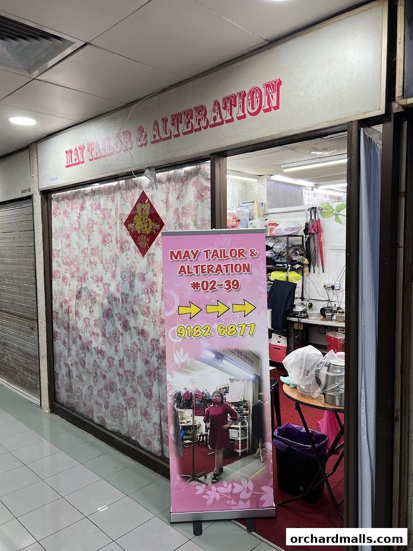 Shopfront of May Tailor & Alteration with a banner displaying contact information.