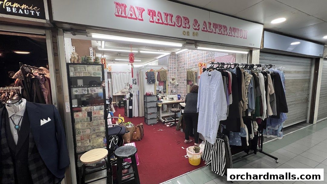 May Tailor & Alteration shop front with clothing racks and tailoring equipment visible inside.