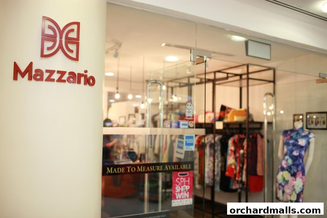 Mazzario shop front with clothing displays and a mannequin wearing a floral dress.