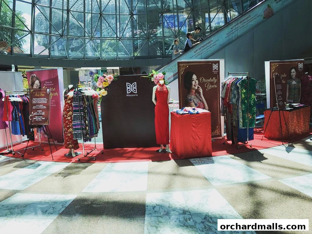 Mazzario shop display featuring traditional Chinese dresses and mannequins.