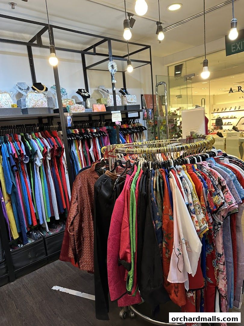 A retail shop interior displaying a variety of colorful clothing and accessories on racks.