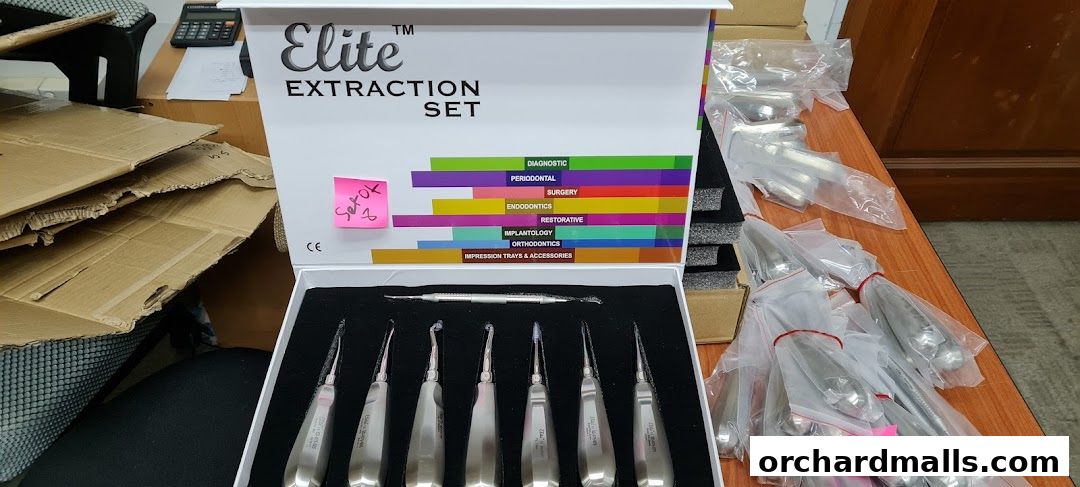 A box of Elite Extraction Set dental instruments and other packaged dental tools.