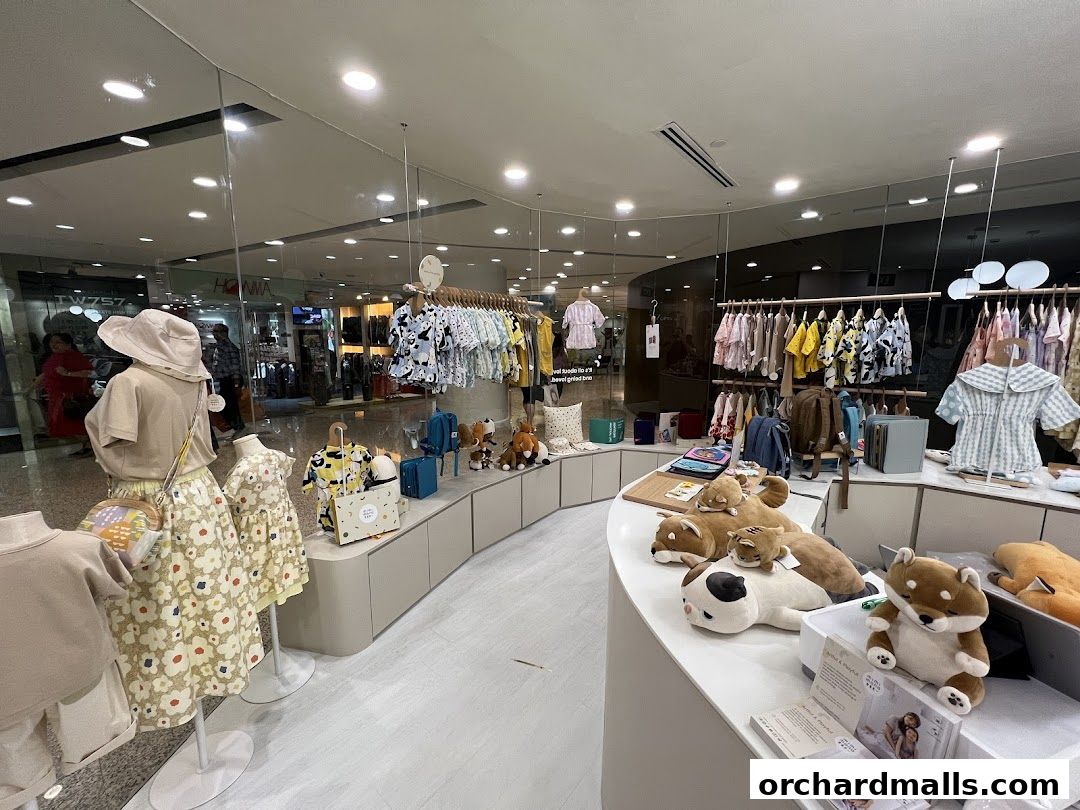 Interior view of a children's clothing store with mannequins and plush toys.