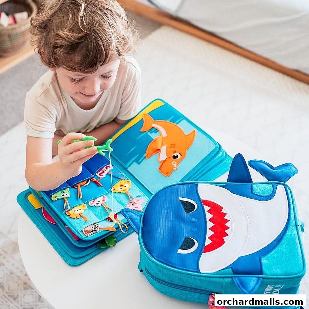 A young child plays with a shark-themed felt book and backpack.
