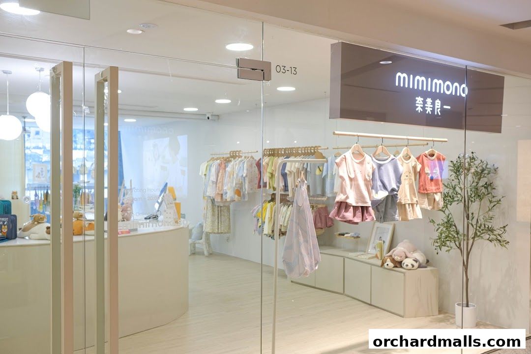 A bright and inviting children's clothing store with clothes displayed on racks and a counter inside.