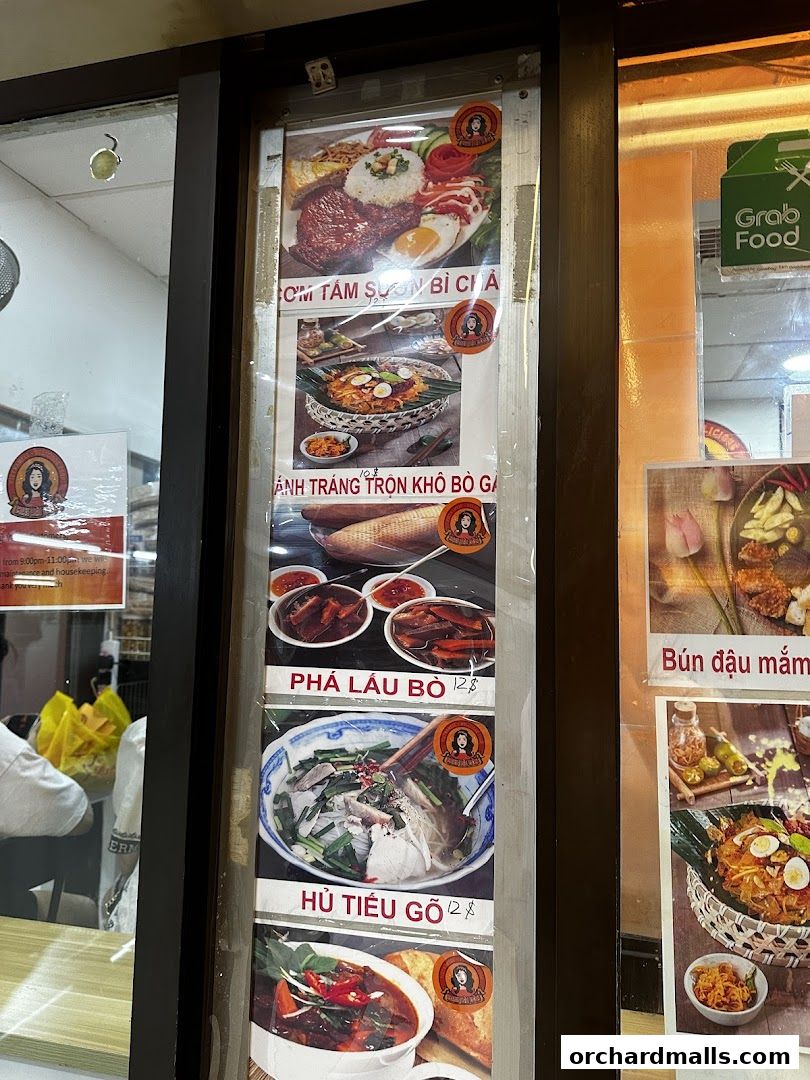 A display of Vietnamese dishes with prices and images outside a restaurant.